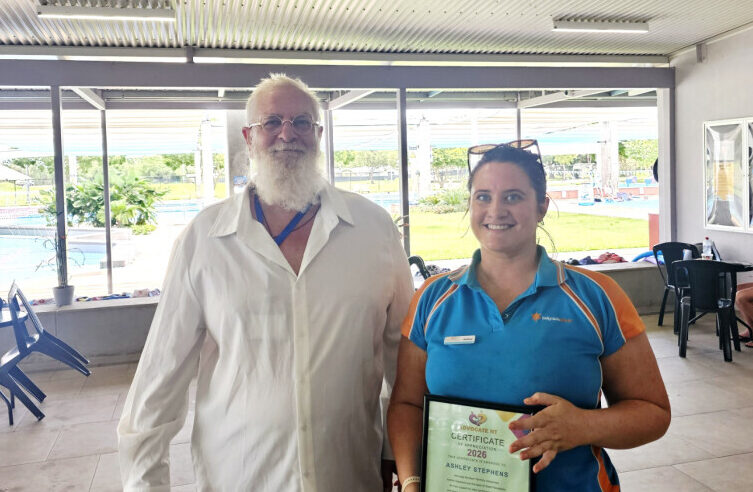 Ashley Stephens and Craig Kelly standing together holding the Community Appreciation Award.